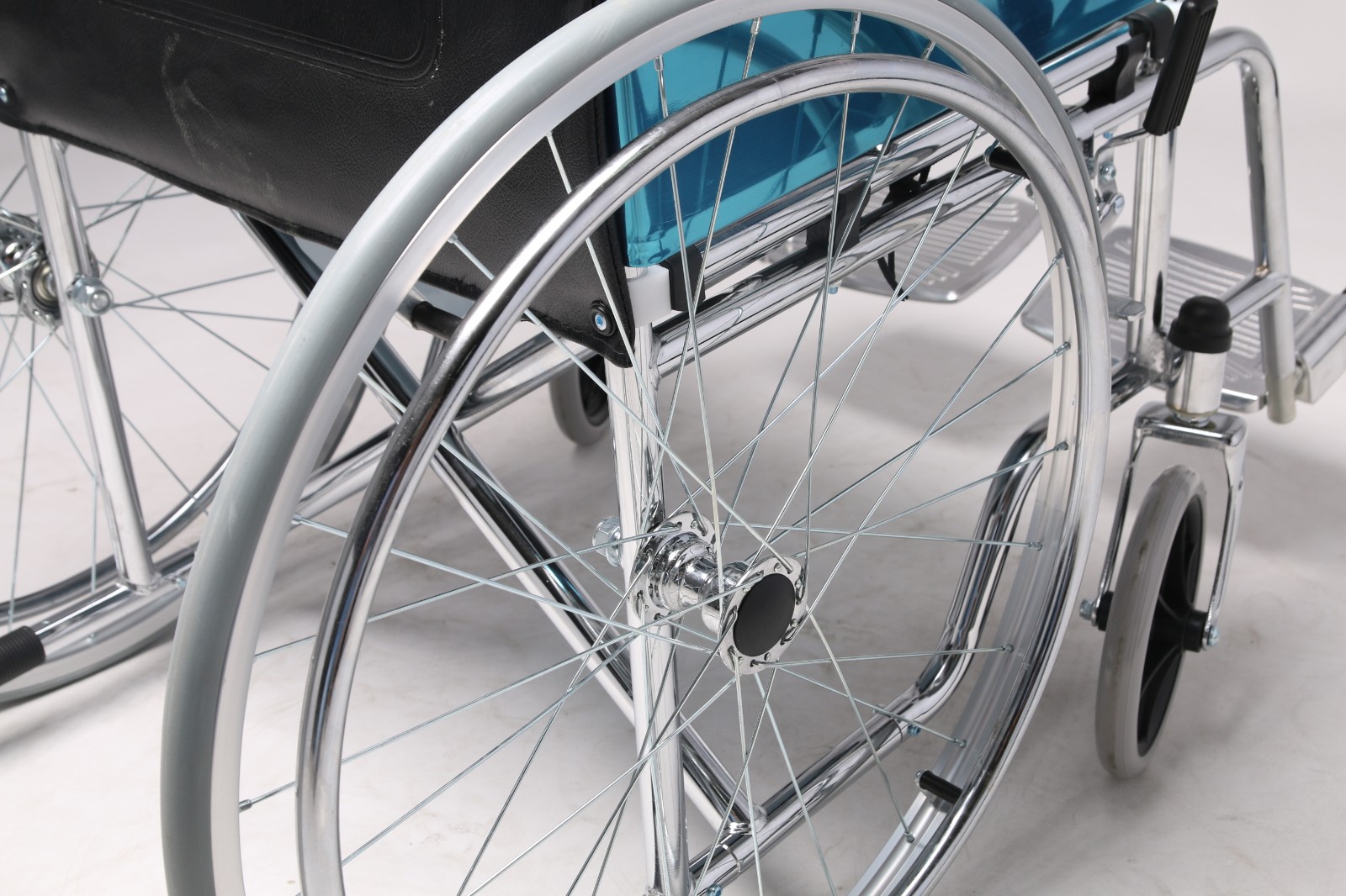 Foldable standard manual wheelchair with large rear wheels, footrests and caregiver push handles in Kenya